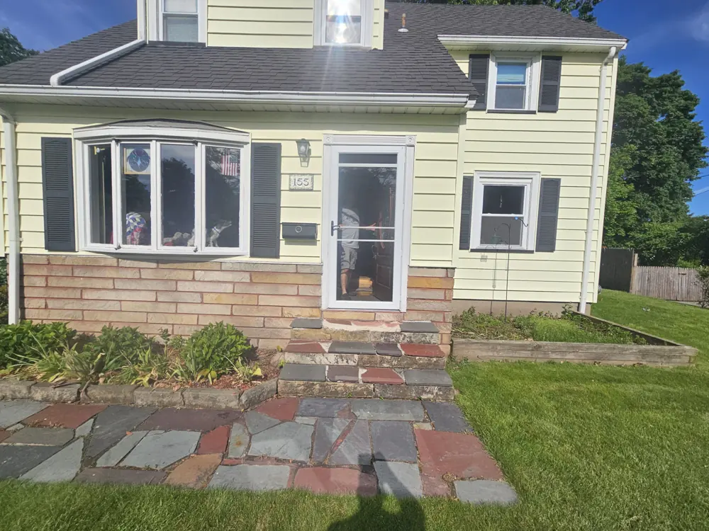 Flagstone walkway leading to the front door of a house